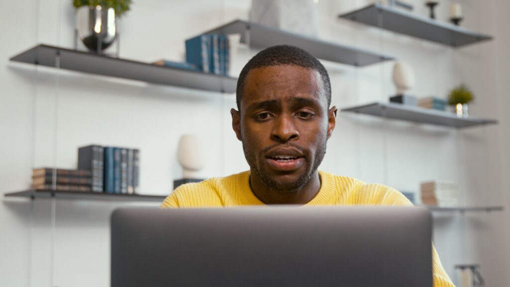 A young man who received bad news while surfing the internet. The stress of receiving bad news | Disqualifications from Obtaining a Learners Licence in South Africa: Clearing the Path to Driving Success