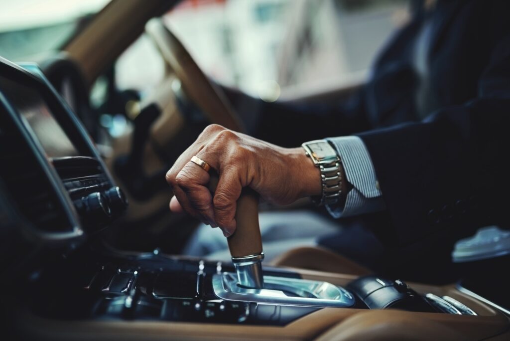 All geared and good to go. Cropped shot of a businessman changing the gears of a car.