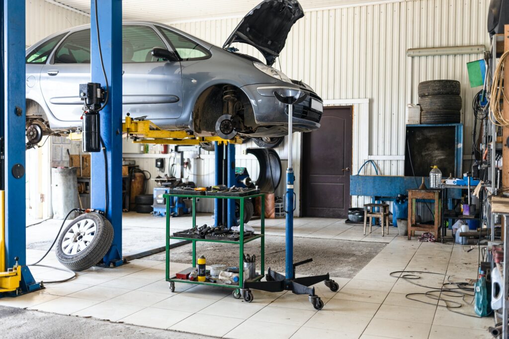 car is lifted on hydraulic lift in car workshop | Step-by-Step Guide to the Exterior Vehicle Inspection