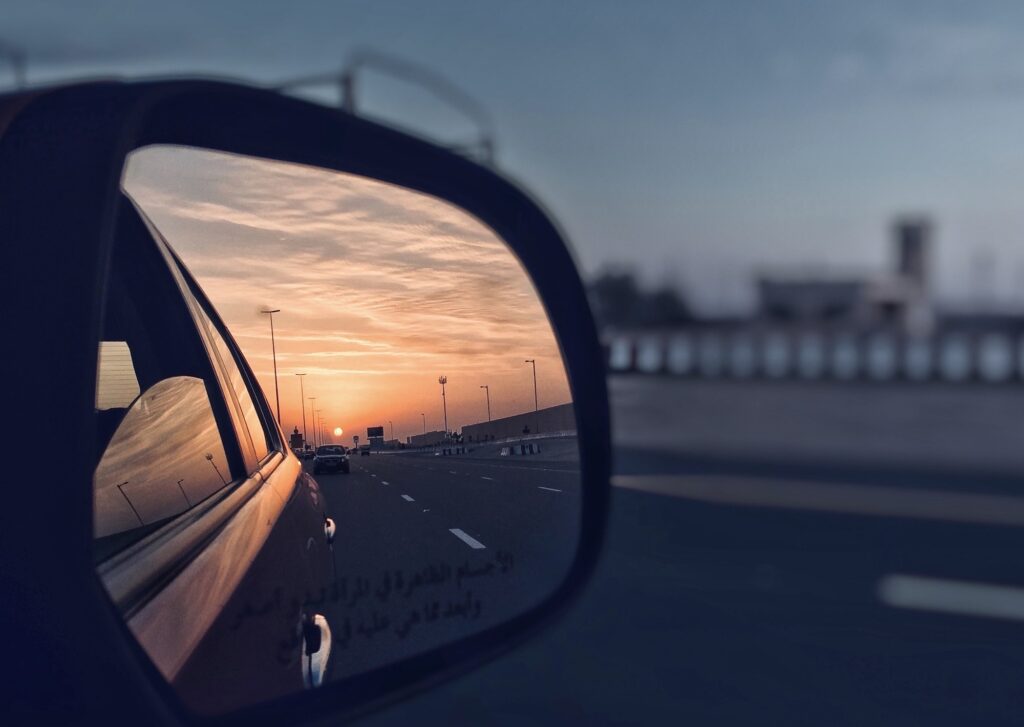 Car side mirror and the sunset | Mastering Mirror Usage for a Successful K53 Driving Licence Test