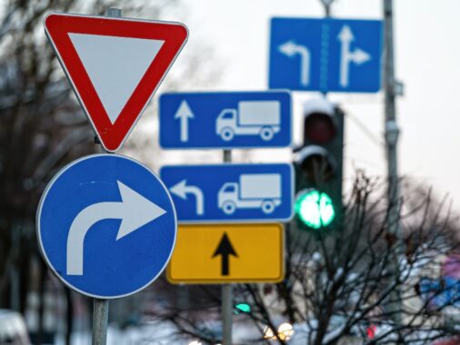 Cars moving on the road in city in winter. View to the traffic with signs, traffic lights and cars | K53 Command Signs