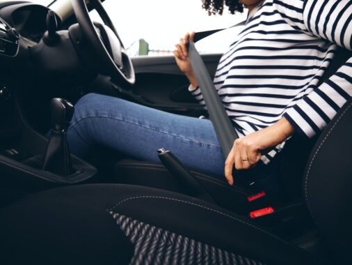 Art of Moving Off | Step-by-Step Guide to Confident Starts | Close Up Of Female Driver In Car Fastening Seatbelt At Start Of Journey