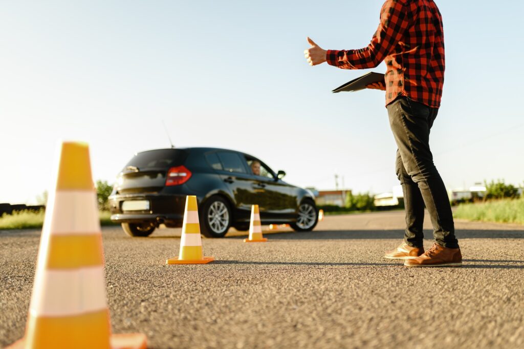 Instructor helps student to drives between cones | Maximizing the Validity of Your Learners Licence 