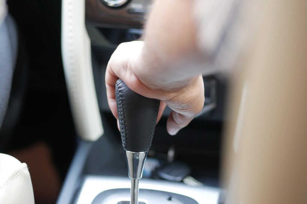 Male hand changing gear in the car,