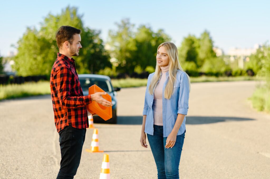 Male instructor with traffic cone and student | Mastering Alley Docking: Conquer the K53 Driving Licence Test with Ease