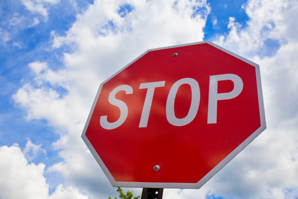 Red stop sign on the street, roadside traffic for stopping.  | K53 Regulatory Signs