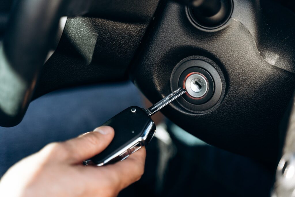 Art of Moving Off | Avoiding Common Errors | Selective focus of the male hand winds up the car ignition key