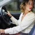 Woman driving a car in reverse: Mastering the Straight-Line Reverse Like a Pro