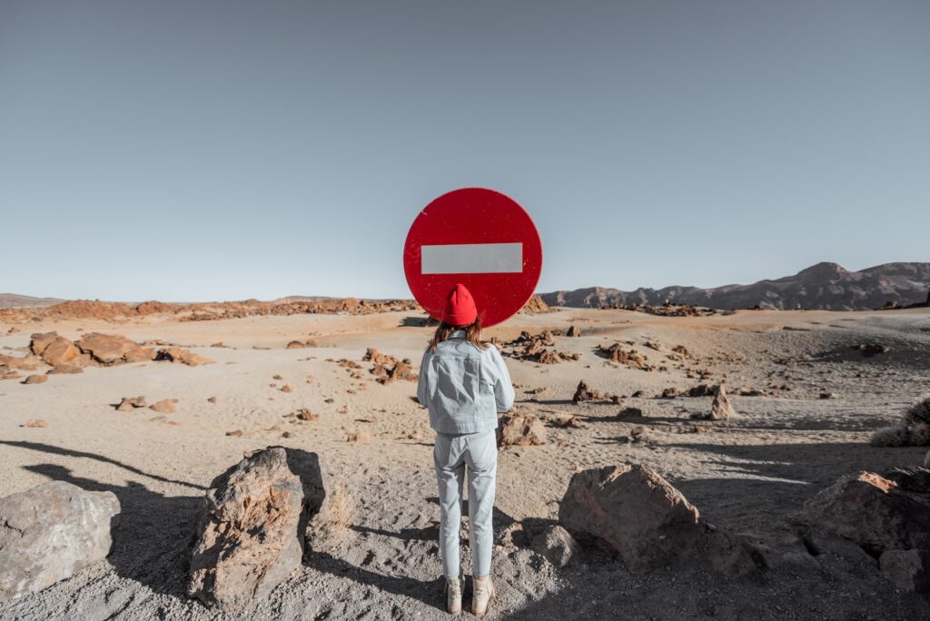 Woman near the traffic sign on the roadside  | K53 Regulatory Signs